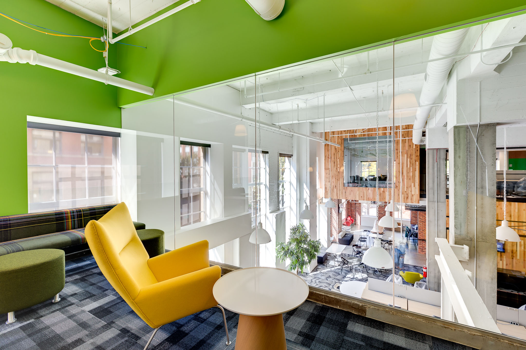 Corner office with green walls and yellow chair